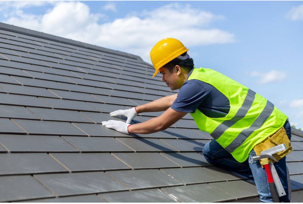 man on roof performing Roofing Services Athens GA, new roof installation for a roof replacement